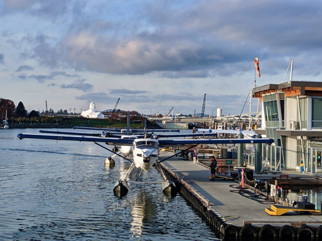 Line of seaplanes docked next to landing platform in Victoria