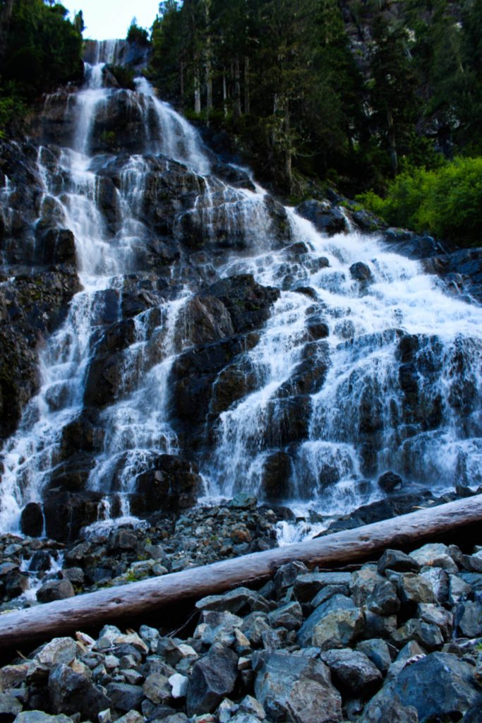 A tall waterfall cascades towards camera, with multiple drops